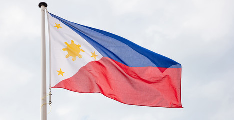 Philippines flag waving against cloudy sky background