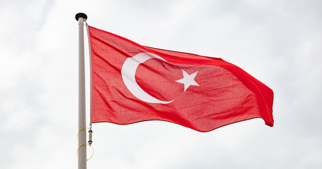 Turkish flag waving against cloudy sky background