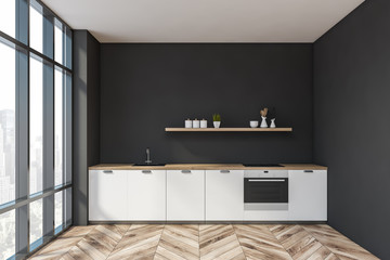 Black kitchen interior with white countertops
