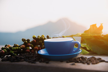 Naklejka na ściany i meble Coffee in morning on mountain view. Coffee cup with mountain background. Coffee in morning time - Image