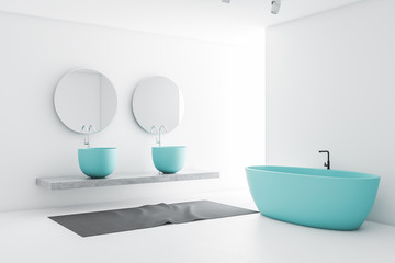 Fototapeta na wymiar White bathroom with blue sink and tub