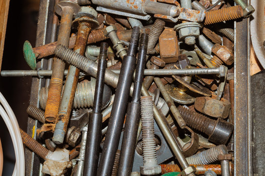 Pile of fasteners and screws close up. scrap metal. different metal parts