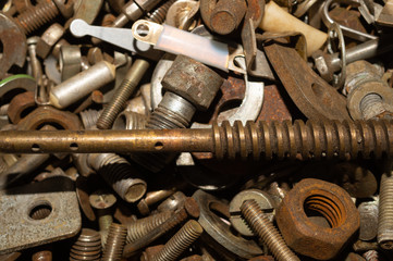 Pile of fasteners and screws close up. scrap metal. different metal details