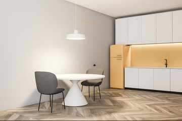 Light gray and yellow kitchen corner with fridge