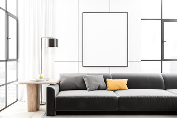 White living room interior with sofa and poster