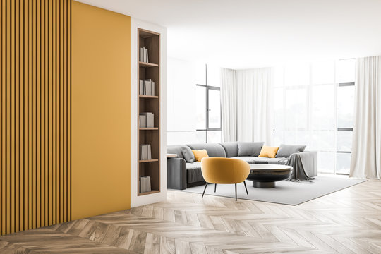White and yellow living room corner with bookcase