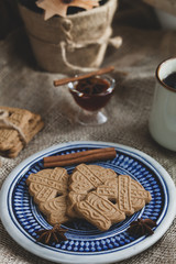 speculoos Christmas cookies on a plate with the Bavarian flag with star anise, honey and cinnamon, the effect of the film and tinting, soft focus and bokeh