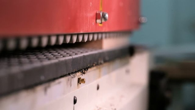 Edging of furniture parts in a woodworking workshop. Machine for gluing edges on chipboard parts. Shallow depth of field. Industrial production and craft. Video with sound.
