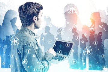 Man with laptop in city, social network icons