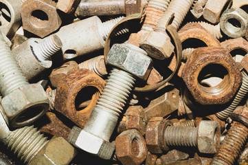 Bolts and nuts of different sizes. scrap metal. industrial background