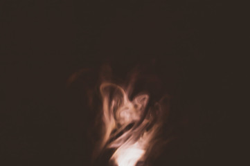 Colored smoke on black backdrop. abstract background with brown fog