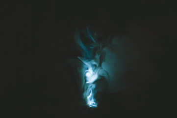 Turquoise smoke on black backdrop. abstract background with color fog