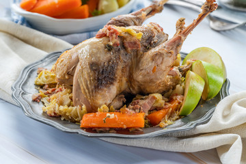 Pot-roast pheasant in cider with bacon and vegetables