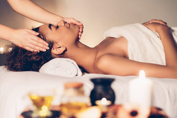 Relaxed lady enjoying aroma therapy in spa salon