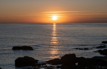 Fototapeta na wymiar Cala Bona Majorca a beautiful sunrise over the Mediterranean with the sun rays reflecting off the sea. 
