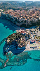 Aerial view of Tropea, house on the rock and Sanctuary of Santa Maria dell'Isola, Calabria. Italy. Tourist destinations of the most famous in Southern Italy, seaside resort located on a cliff  - obrazy, fototapety, plakaty