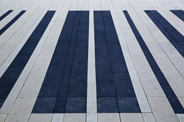 Plot of city square lined with rectangular slabs of black and white © miraleks