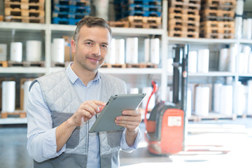 businessman using digital tablet in a warehouse