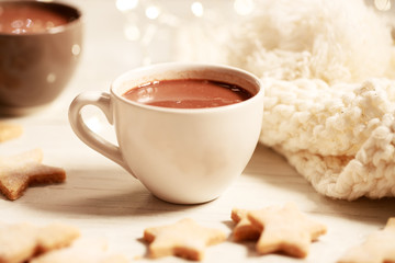 Hot chocolate in white cup with star shaped cookies