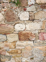 Wall with natural Sicilian stones, texture and background.