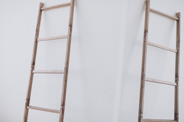 a wooden staircase stands in a white room