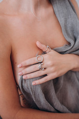 girl half naked shows rings on her hands
