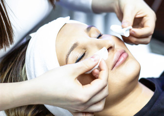 Skin cleansing. Young woman enjoying facial cleanses in a beauty salon, cosmetology skin care treatment face cosmetologist professionalism spa wellbeing youth freshness clinic concept