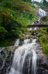 A group of tourism on a bridge at Silver Waterfall Sa Pa district Lao Cai province Vietnam