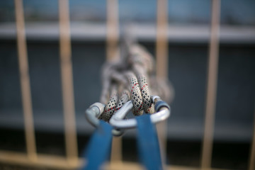 Closeup pic of blue tapes sling rigged with locking karabiners and clipping into static twin ropes,...