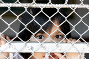little girl hold cage with eye sad and hopeless, Human trafficking concept, human rights...