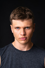 Obraz premium Portrait of young man over isolated black background