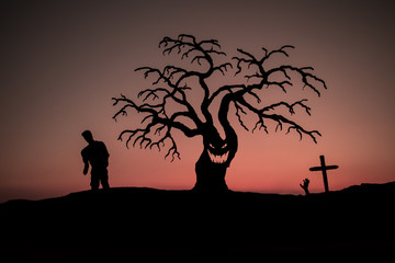 Silhouette some zombies on the cemetery walking around at sunset. Selective focus