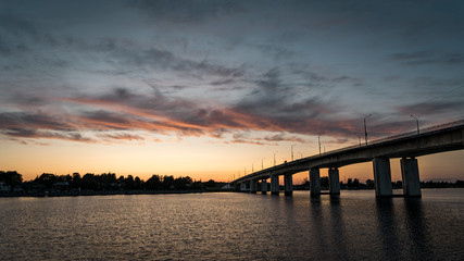 Fototapeta na wymiar Kostroma. Gold ring of Russia. Bridge over the Volga river. Clouds in the evening sky.