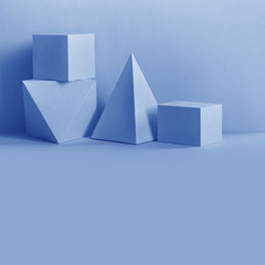 Abstract geometrical composition. Prism pyramid rectangular cube objects on blue background....