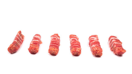 Chevapchichi in bacon isolated on white background.