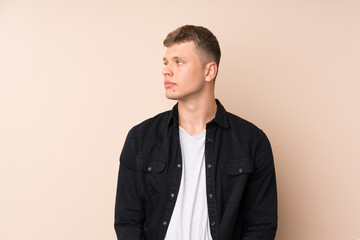 Young handsome man looking side
