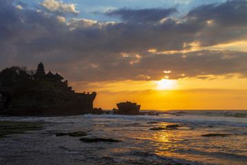 Tanah Lot in golden sunset, Bali, Indonesia.