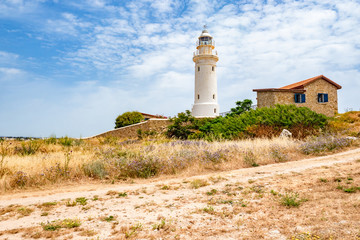 Fototapeta na wymiar Republic of Cyprus. Pathos. Lighthouse on the coast. Archaeological park. Paphos archaelogical site. Lighthouse on the shores of the Mediterranean Sea. Walks in Cyprus. House Near Lighthouse
