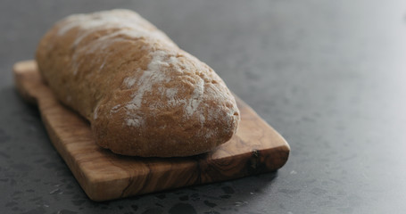 ciabatta bread on olive board