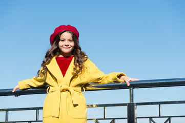 Fototapeta na wymiar Happy to be around. kid fashion. stylish girl child after hairdresser. she has curly hair. trip to france. enjoy autumn day. lucky with weather. cute little lady. small girl outdoor. true parisian
