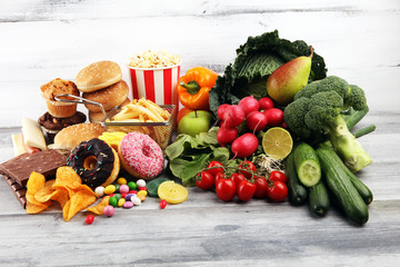 healthy or unhealthy food. Concept photo of healthy and unhealthy food. Fruits and vegetables vs...