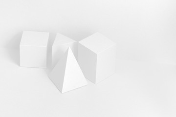 Photography geometrical Platonic solids figures still life composition, simplicity concept. Three-dimensional prism pyramid rectangular cube objects on white background.