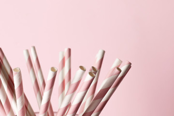 A lot of pink paper straws on a background. Top view. Place for text. Party concept.
