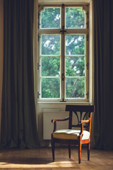 Old Vintage Chair in the Empty Room with Big Window