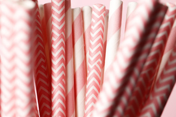 A lot of pink paper straws close-up on a background. Top view. Place for text. Party concept.
