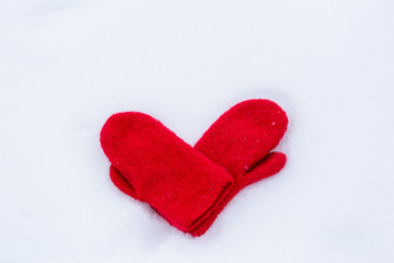 Heart shaped mittens on snow