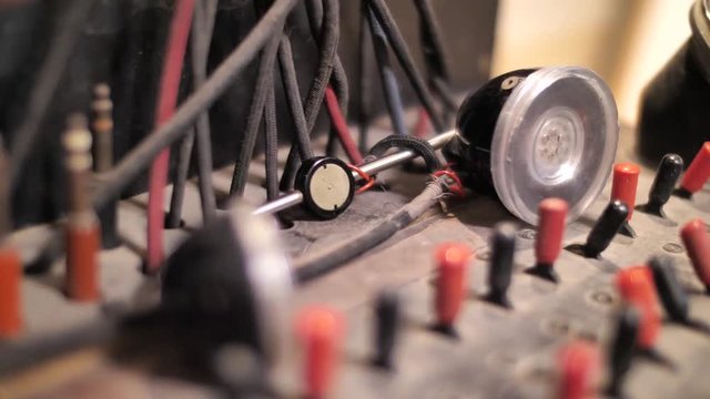 Hand putting down headset on switchboard in telephone exchange