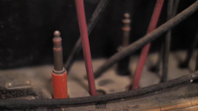 Manual vintage telephone exchange. Close up on hand picking up jack