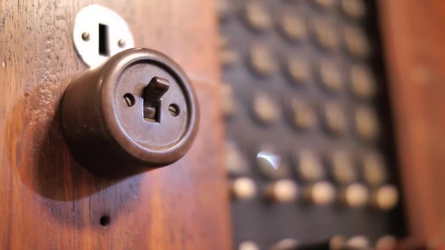 Changing switch position on antique telephone exchange, close up