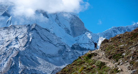 Active hiker hiking, enjoying the view  at Himalaya mountains and Mount Ama Dablam landscape. Travel sport lifestyle concept
